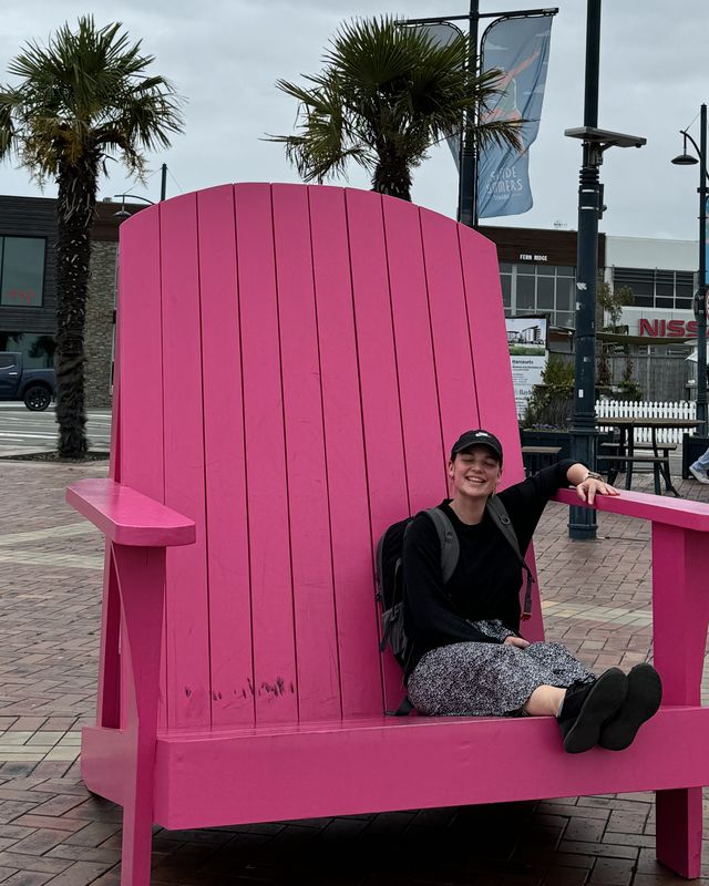 Julia sitting in a giant pink chair