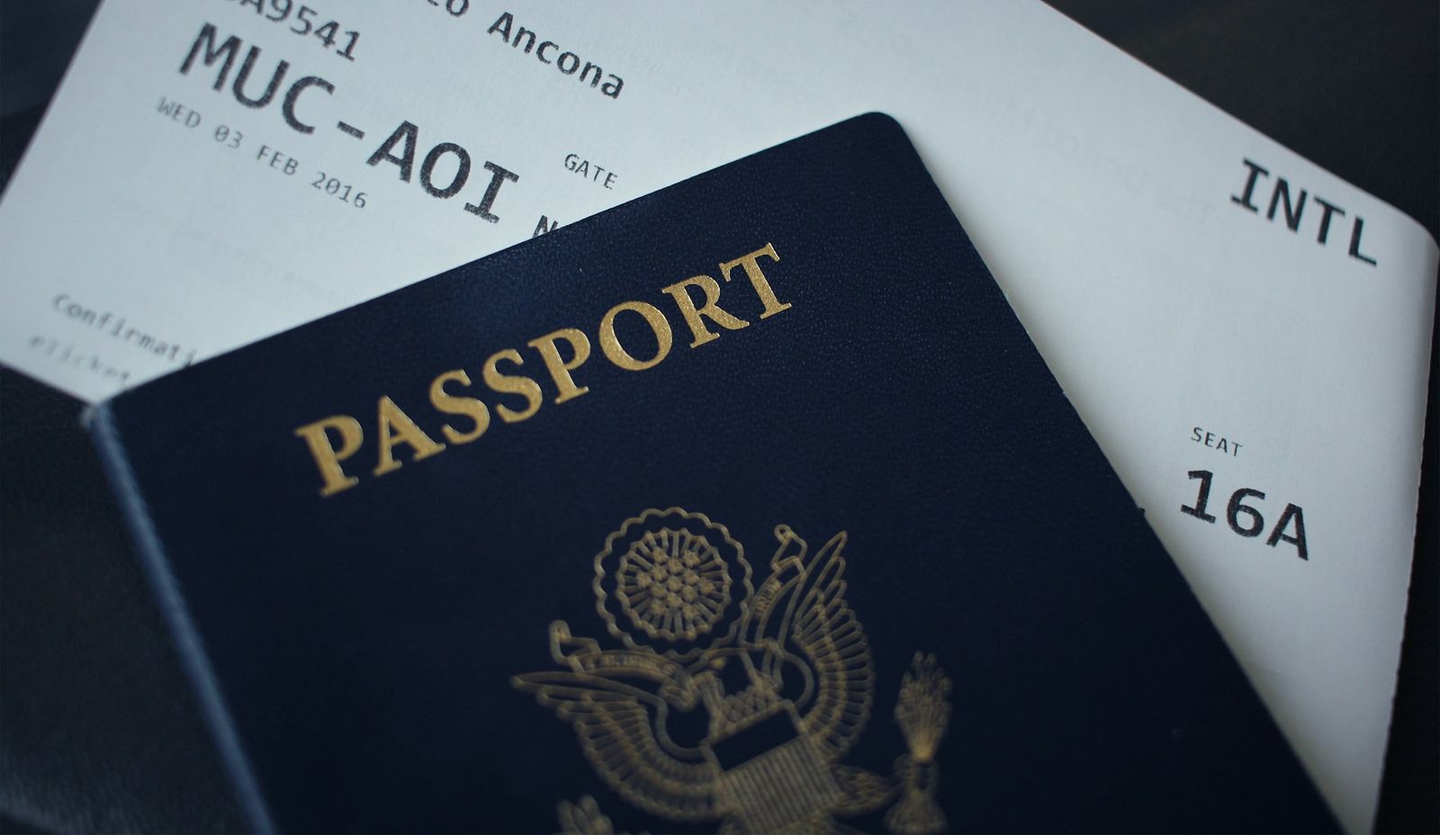 A US passport lying on a boarding pass